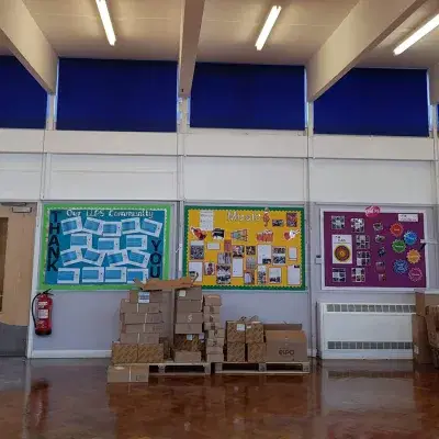 Blue roller blinds in a school hall