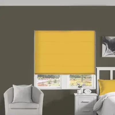 Yellow roman blinds on a bedroom window