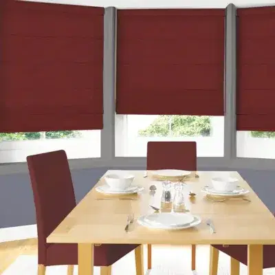 Red roman blinds on a bay window