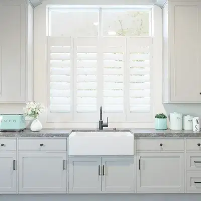 Thick white shutters on a kitchen window