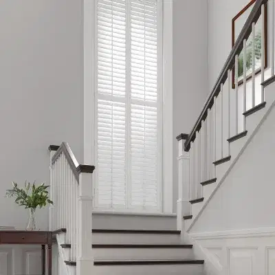 White shutters on a tall landing window