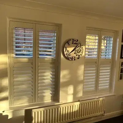 white shutters on two windows