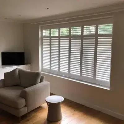 White shutters on a large living room window