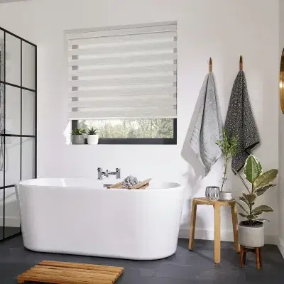 Grey and transparent striped vision blinds in a bathroom